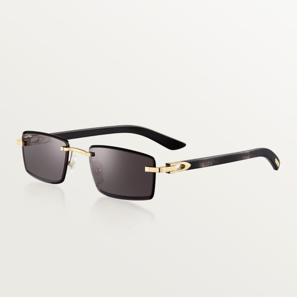 Sunglasses with Elongated C de Cartier motif Smooth golden-finish metal, black horn, grey lenses