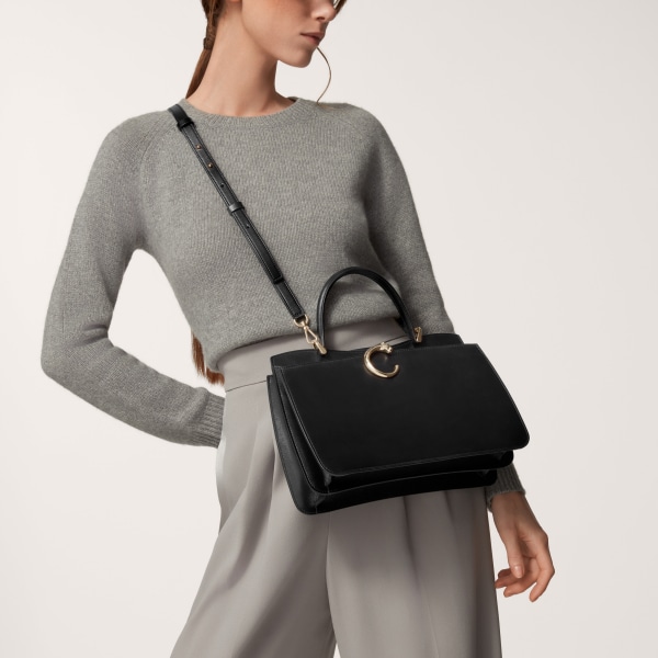 Top handle bag small model, Panthère de Cartier Black calfskin, golden finish