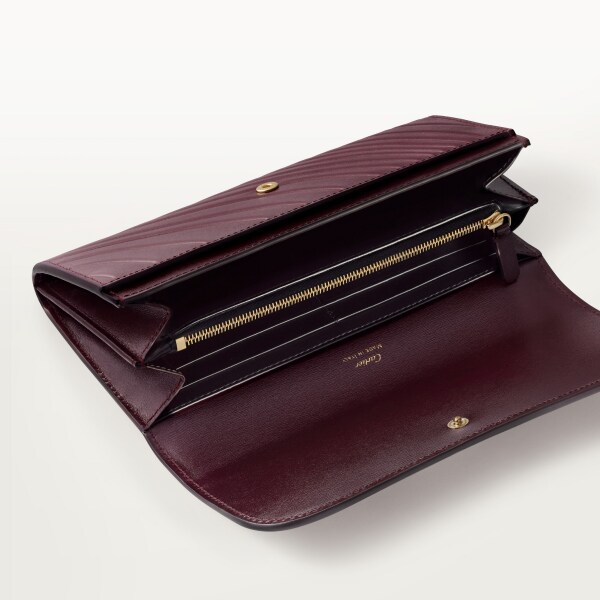 International wallet with flap, Panthère C Grape calfskin, embossed Cartier signature motif, golden finish