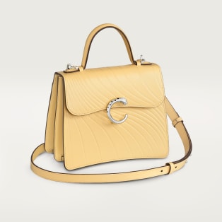 Small model handle bag, Panthère C de Cartier Mimosa yellow calfskin, embossed with Cartier signature motif, palladium finish