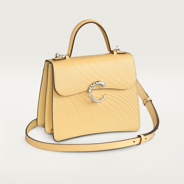 Small model handle bag, Panthère C de Cartier Mimosa yellow calfskin, embossed with Cartier signature motif, palladium finish