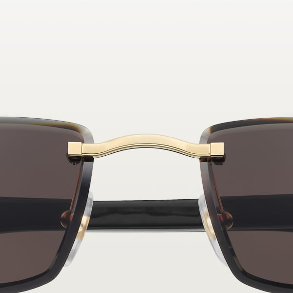Sunglasses with Elongated C de Cartier motif Smooth golden-finish metal, black horn, grey lenses