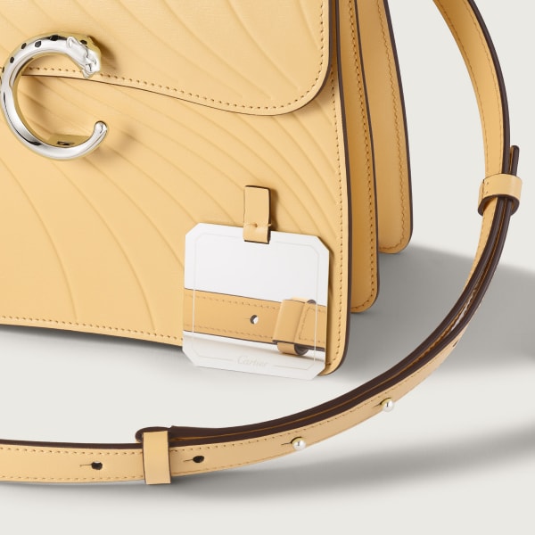 Small model handle bag, Panthère C de Cartier Mimosa yellow calfskin, embossed with Cartier signature motif, palladium finish