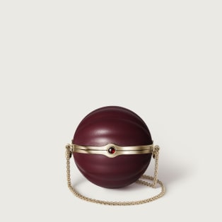 Round bag with gadroon motif, Cartier Soir Burgundy lambskin, hessonite garnet and golden finish