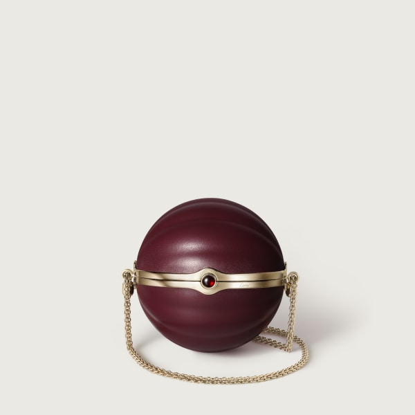 Round bag with gadroon motif, Cartier Soir Burgundy lambskin, hessonite garnet and golden finish