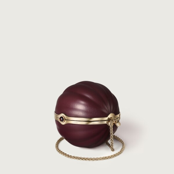 Round bag with gadroon motif, Cartier Soir Burgundy lambskin, hessonite garnet and golden finish