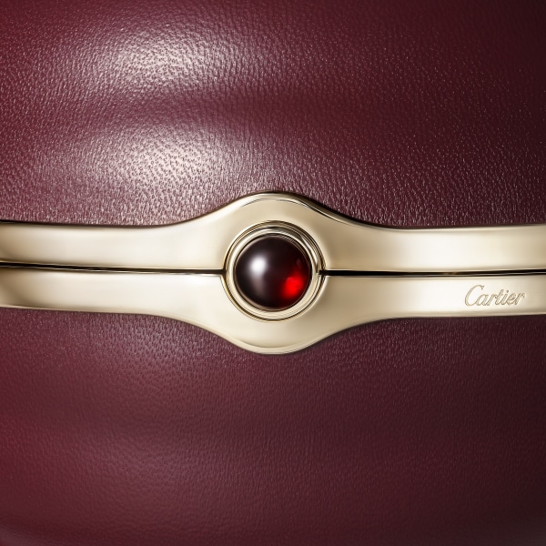 Round bag with gadroon motif, Cartier Soir Burgundy lambskin, hessonite garnet and golden finish