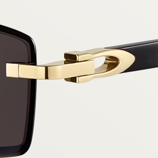 Sunglasses with Elongated C de Cartier motif Smooth golden-finish metal, black horn, grey lenses