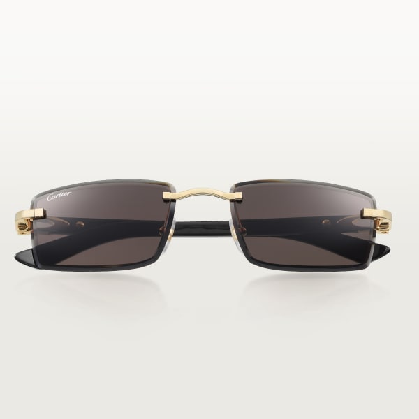 Sunglasses with Elongated C de Cartier motif Smooth golden-finish metal, black horn, grey lenses