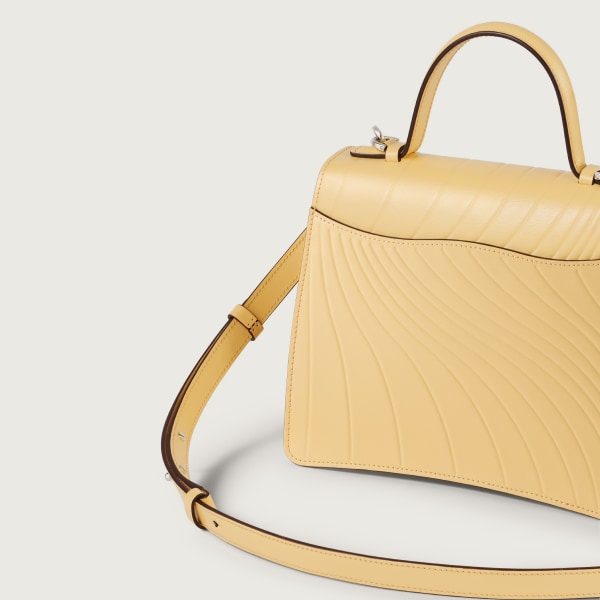 Small model handle bag, Panthère C de Cartier Mimosa yellow calfskin, embossed with Cartier signature motif, palladium finish