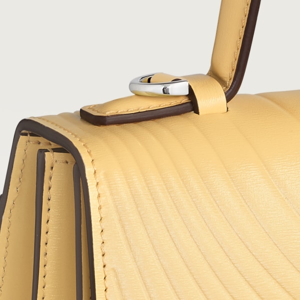 Small model handle bag, Panthère C de Cartier Mimosa yellow calfskin, embossed with Cartier signature motif, palladium finish