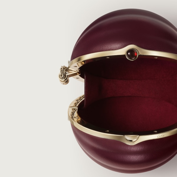 Round bag with gadroon motif, Cartier Soir Burgundy lambskin, hessonite garnet and golden finish